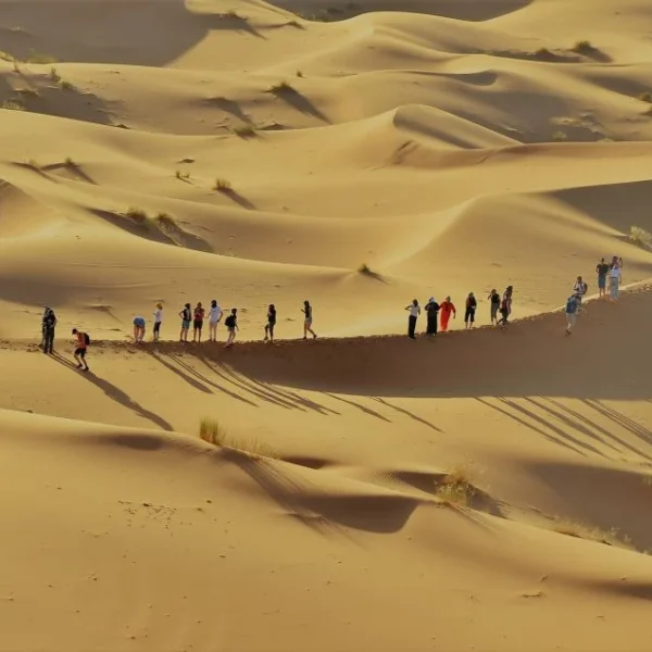 group of Tourist enjoying sahara dunes on 6 days tour from Marrakech