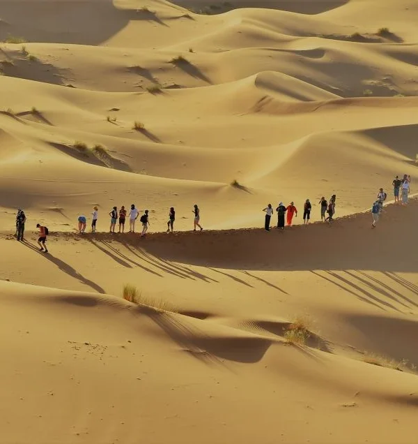 group of Tourist enjoying sahara dunes on 6 days tour from Marrakech