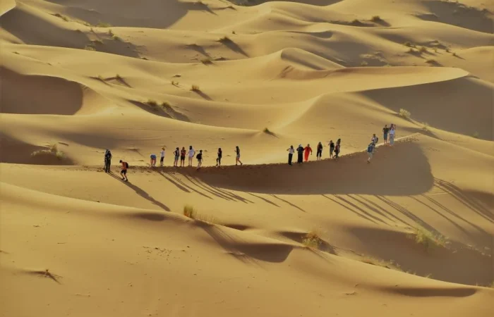 group of Tourist enjoying sahara dunes on 6 days tour from Marrakech
