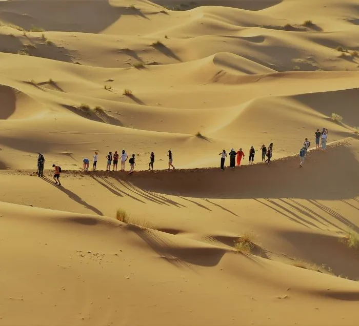 group of Tourist enjoying sahara dunes on 6 days tour from Marrakech