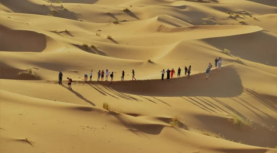 group of Tourist enjoying sahara dunes on 6 days tour from Marrakech