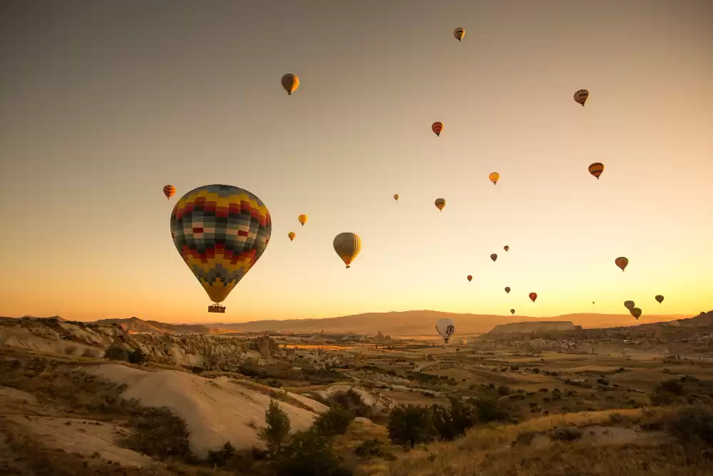 People Enjoying Hot Air Balloon ride in Marrakech on a sunset