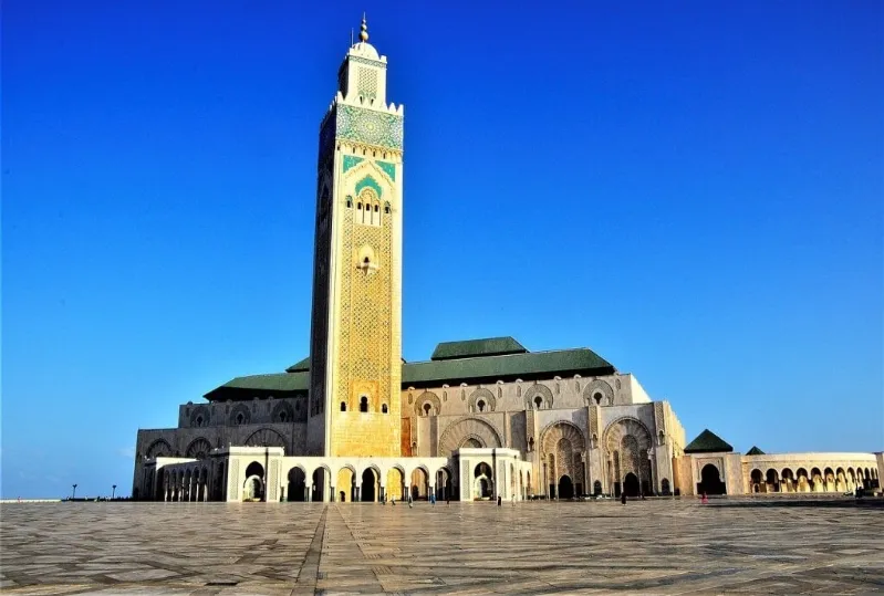 The Hassan II Mosque in Casablanca, Morocco, showcasing its stunning architecture against a clear blue sky.