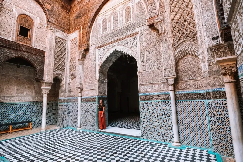 Interior of an old Moroccan building featuring a classic checkered floor, part of a travel itinerary.
