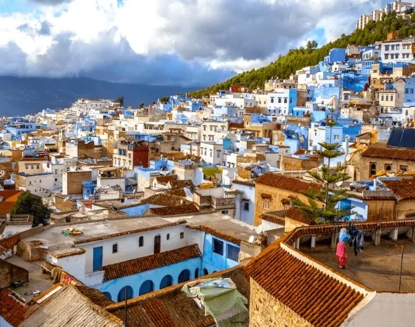 Scenic view of Chefchaouen, Morocco, showcasing its iconic blue buildings and mountainous backdrop, ideal for Morocco tours.