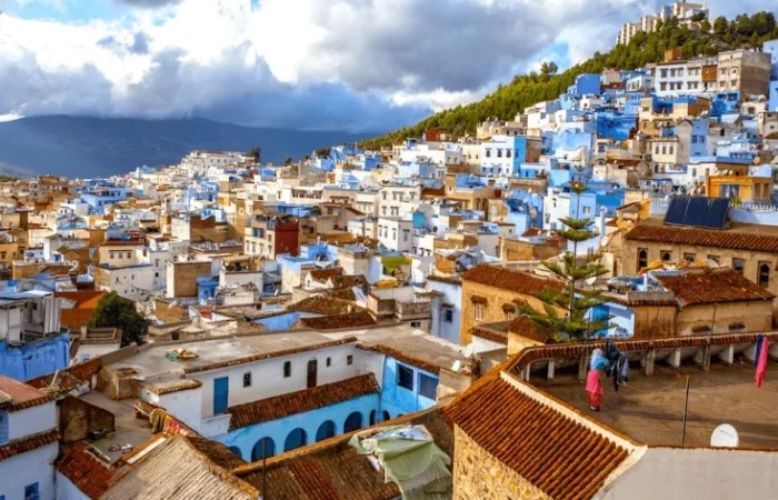 Scenic view of Chefchaouen, Morocco, showcasing its iconic blue buildings and mountainous backdrop, ideal for Morocco tours.