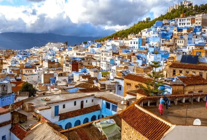 Scenic view of Chefchaouen, Morocco, showcasing its iconic blue buildings and mountainous backdrop, ideal for Morocco tours.