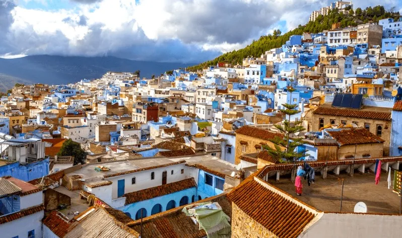 Scenic view of Chefchaouen, Morocco, showcasing its iconic blue buildings and mountainous backdrop, ideal for Morocco tours.