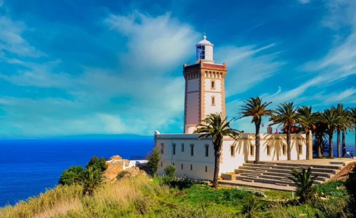 A lighthouse perched on a hill, overlooking the ocean, symbolizing coastal beauty in Morocco.