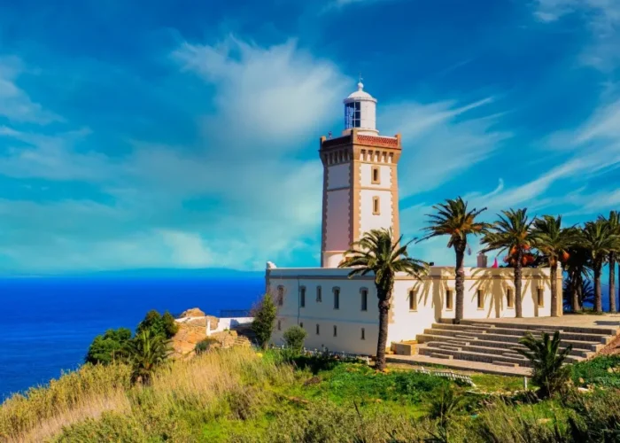 A lighthouse perched on a hill, overlooking the ocean, symbolizing coastal beauty in Morocco.