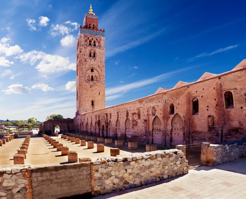 A large building featuring a prominent clock tower, representing a highlight of the Morocco trip package.