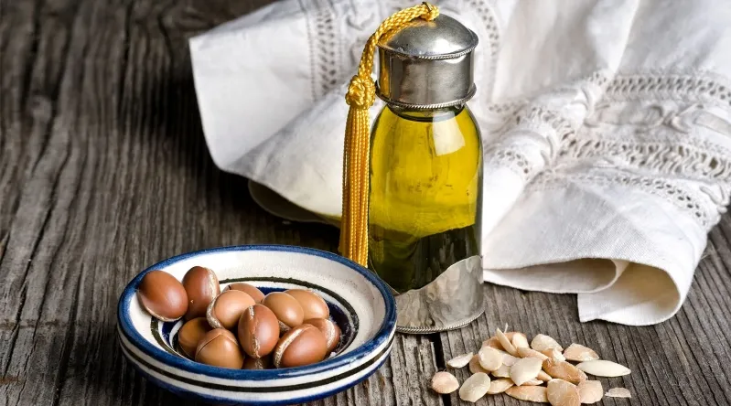 Visual representation of argan oil benefits, showcasing its uses in skincare and haircare, referred to as Moroccan olive oil.