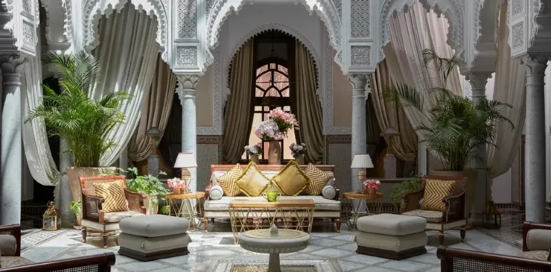 Luxurious hotel living room featuring ornate furniture, showcasing elegance and comfort for guests. Best Morocco Private Tour Company. 