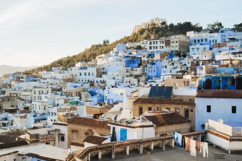 Scenic view of Chefchaouen, Morocco, known for its blue-washed buildings and stunning mountain backdrop, a must-visit destination.