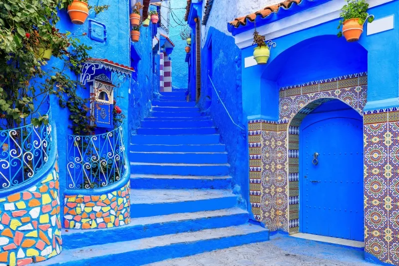 Scenic view of Chefchaouen, Morocco, showcasing its iconic blue buildings and mountainous backdrop, a must-visit destination.