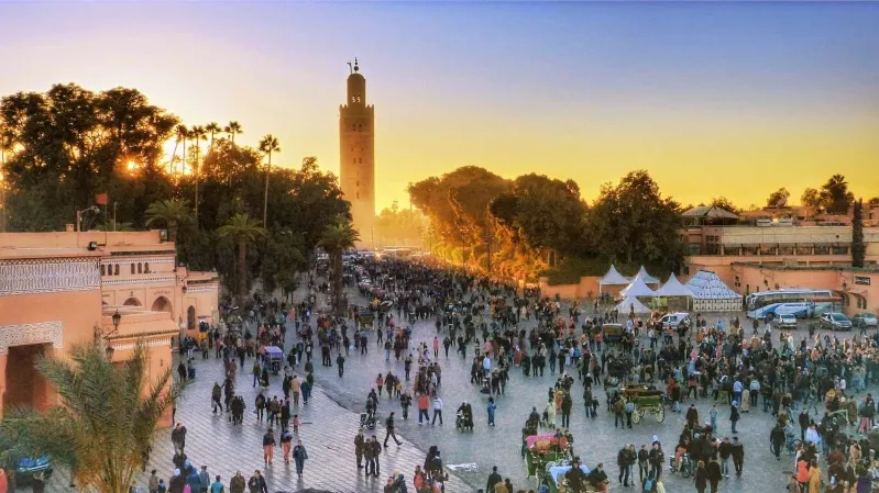 A bustling crowd of people exploring a vibrant city during a Morocco Vacation Travel Guide.