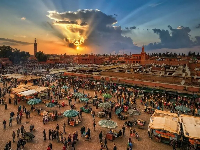 Sunset casts vibrant hues over the city of Marrakech, highlighting its unique architecture and Moroccan travel. 