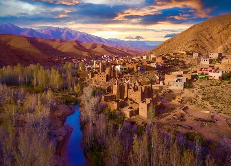 Scenic view of the village of Atlas Private Tours of Morocco, showcasing traditional architecture and surrounding mountainous landscape.