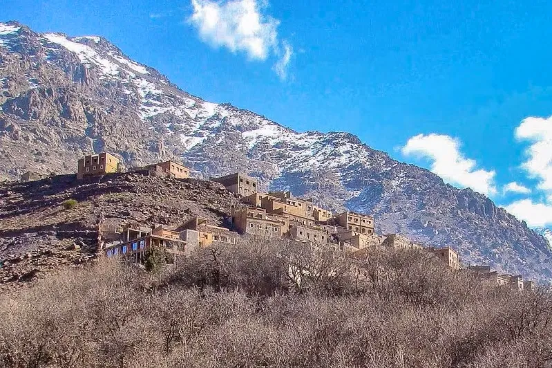 A picturesque mountain village in Morocco, surrounded by snow-capped peaks, ideal for winter tours and adventures.