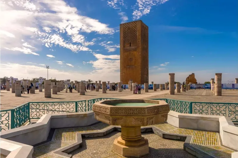 A central fountain in a bustling plaza, surrounded by visitors enjoying the vibrant atmosphere of Rabat, Morocco.