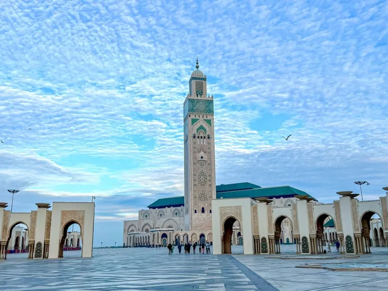 The Hassan II Mosque in Casablanca, Morocco, showcasing its stunning architecture against a clear blue sky.visit Casablanca
