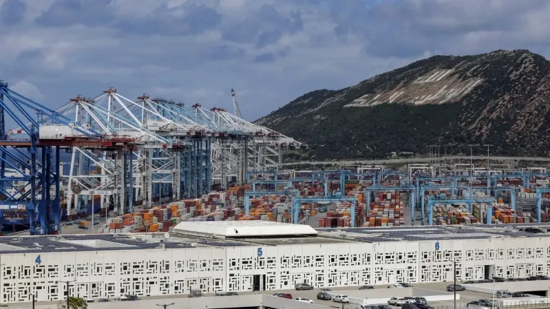 A large container port in Morocco featuring numerous cranes and shipping containers, showcasing maritime activity.