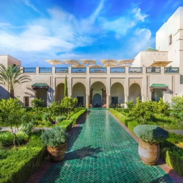 Ruins of a castle in the Moroccan desert at sunset, showcasing luxury travel's blend of history and natural beauty.