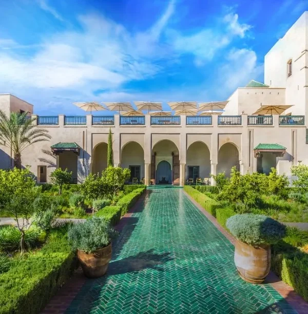 Ruins of a castle in the Moroccan desert at sunset, showcasing luxury travel's blend of history and natural beauty.