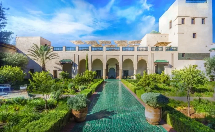 Ruins of a castle in the Moroccan desert at sunset, showcasing luxury travel's blend of history and natural beauty.