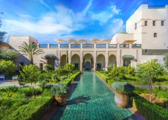 Ruins of a castle in the Moroccan desert at sunset, showcasing luxury travel's blend of history and natural beauty.