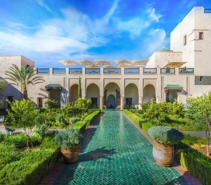 Ruins of a castle in the Moroccan desert at sunset, showcasing luxury travel's blend of history and natural beauty.