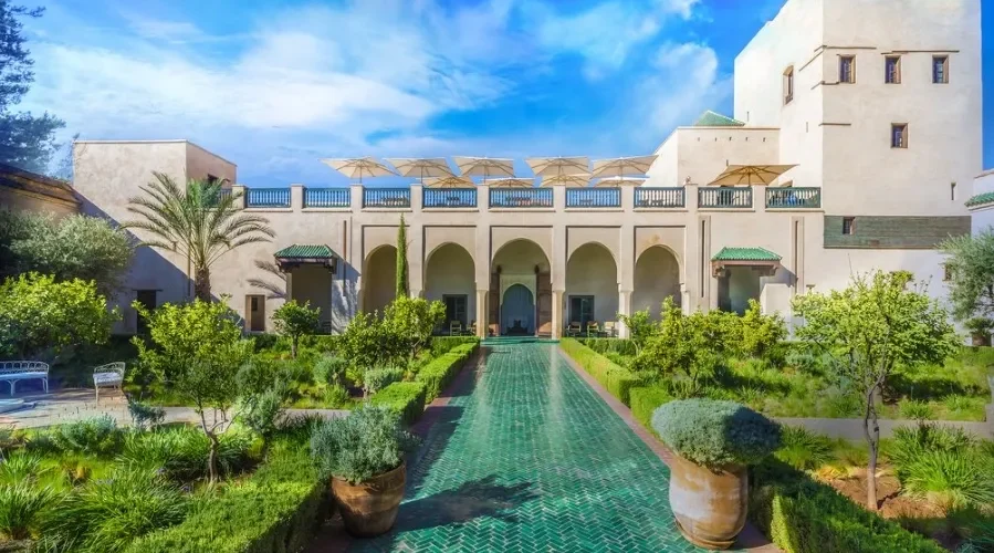 Ruins of a castle in the Moroccan desert at sunset, showcasing luxury travel's blend of history and natural beauty.