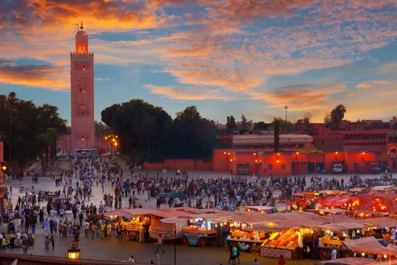 Vibrant sunset in Marrakech, Morocco, capturing the essence of the city, a must-see for Morocco travel tours .
