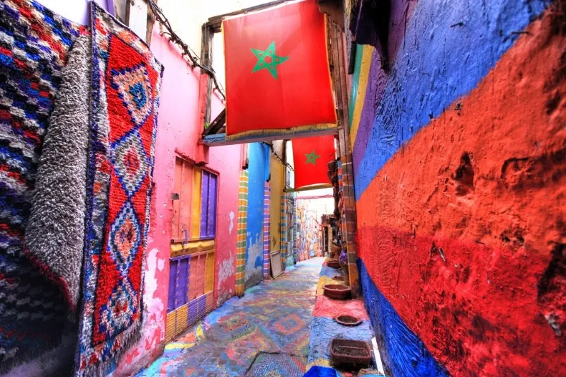 A vibrant alley adorned with colorful flags, showcasing the lively atmosphere of a 10-day Morocco itinerary.