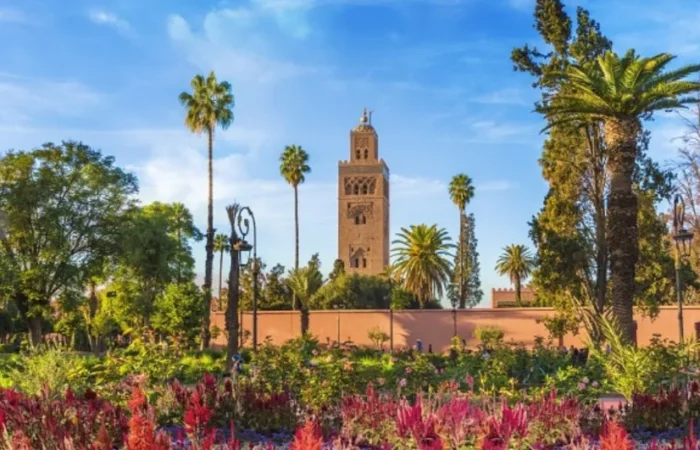 Lush garden of a mosque in Marrakech, Morocco, featuring vibrant plants and serene pathways, ideal for reflection.