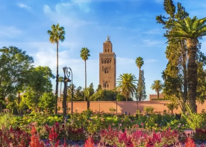 Lush garden of a mosque in Marrakech, Morocco, featuring vibrant plants and serene pathways, ideal for reflection.