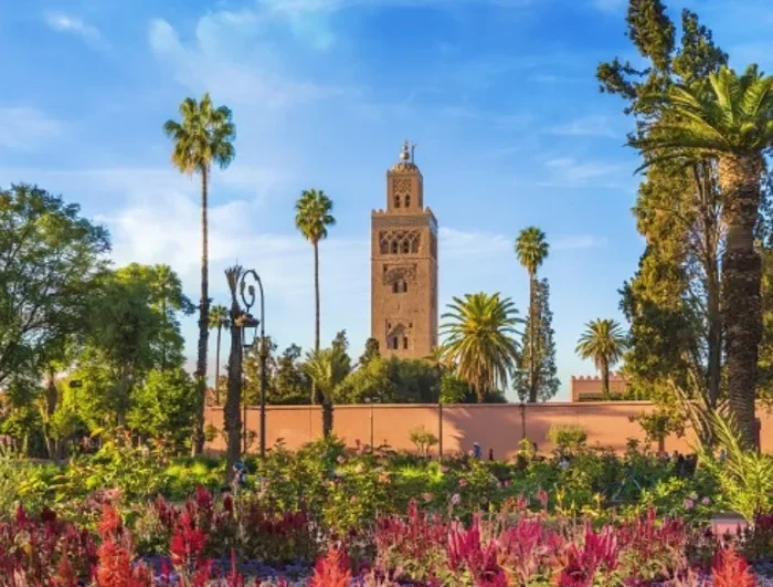 Lush garden of a mosque in Marrakech, Morocco, featuring vibrant plants and serene pathways, ideal for reflection.