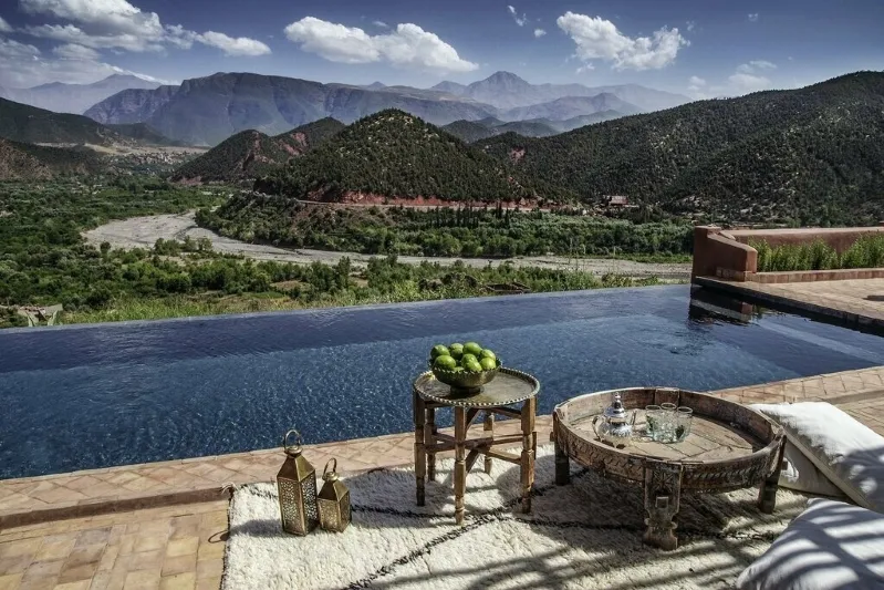 A serene pool overlooking majestic mountains, featured in a Morocco Itinerary 7 Days.