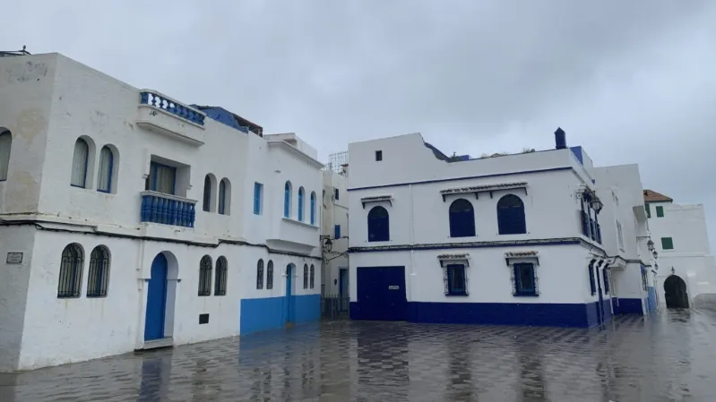 Blue and white buildings under rain, showcasing a typical Moroccan scene, ideal for visiting in spring.best month to visit Morocco
