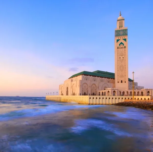 A coastal mosque in Casablanca, showcasing stunning architecture against the backdrop of the ocean.
