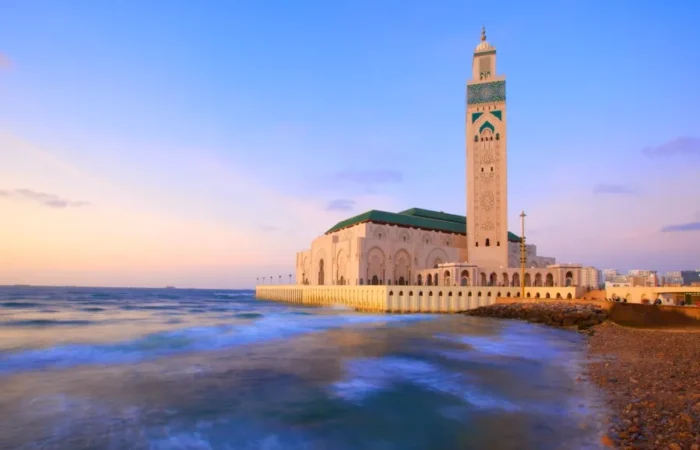 A coastal mosque in Casablanca, showcasing stunning architecture against the backdrop of the ocean.