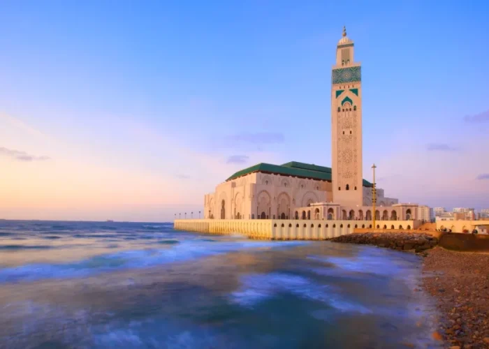 A coastal mosque in Casablanca, showcasing stunning architecture against the backdrop of the ocean.