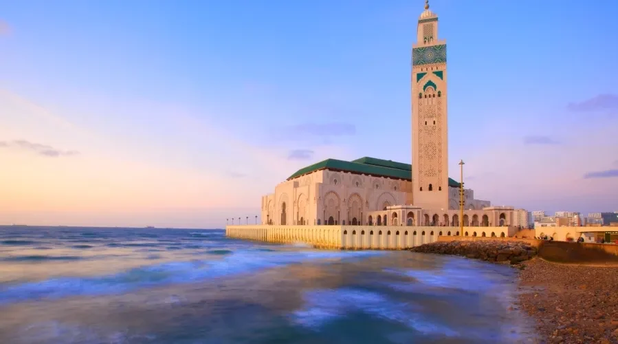 A coastal mosque in Casablanca, showcasing stunning architecture against the backdrop of the ocean.