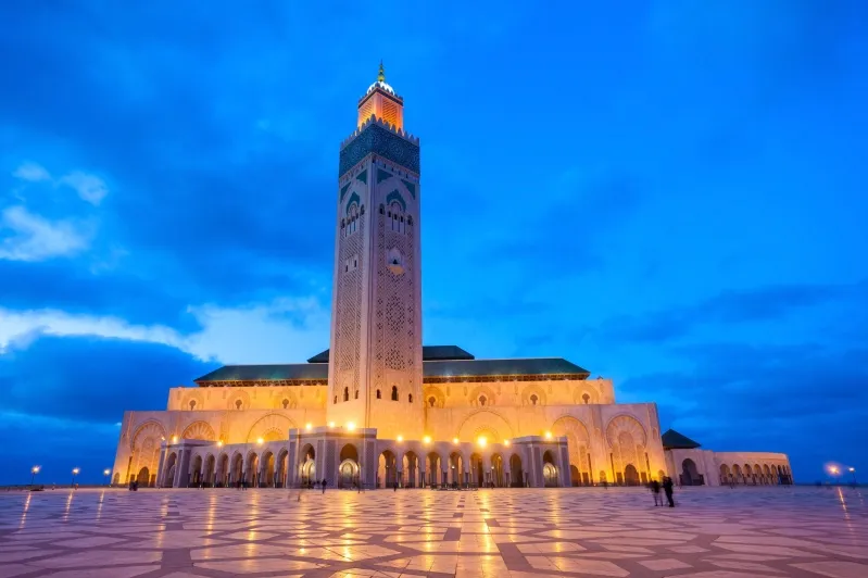 The Hassan II Mosque in Casablanca, Morocco, showcasing its stunning architecture against a clear blue sky.