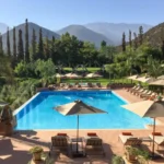 A serene pool area featuring lounge chairs and umbrellas, ideal for relaxation during luxury private tours in Morocco.