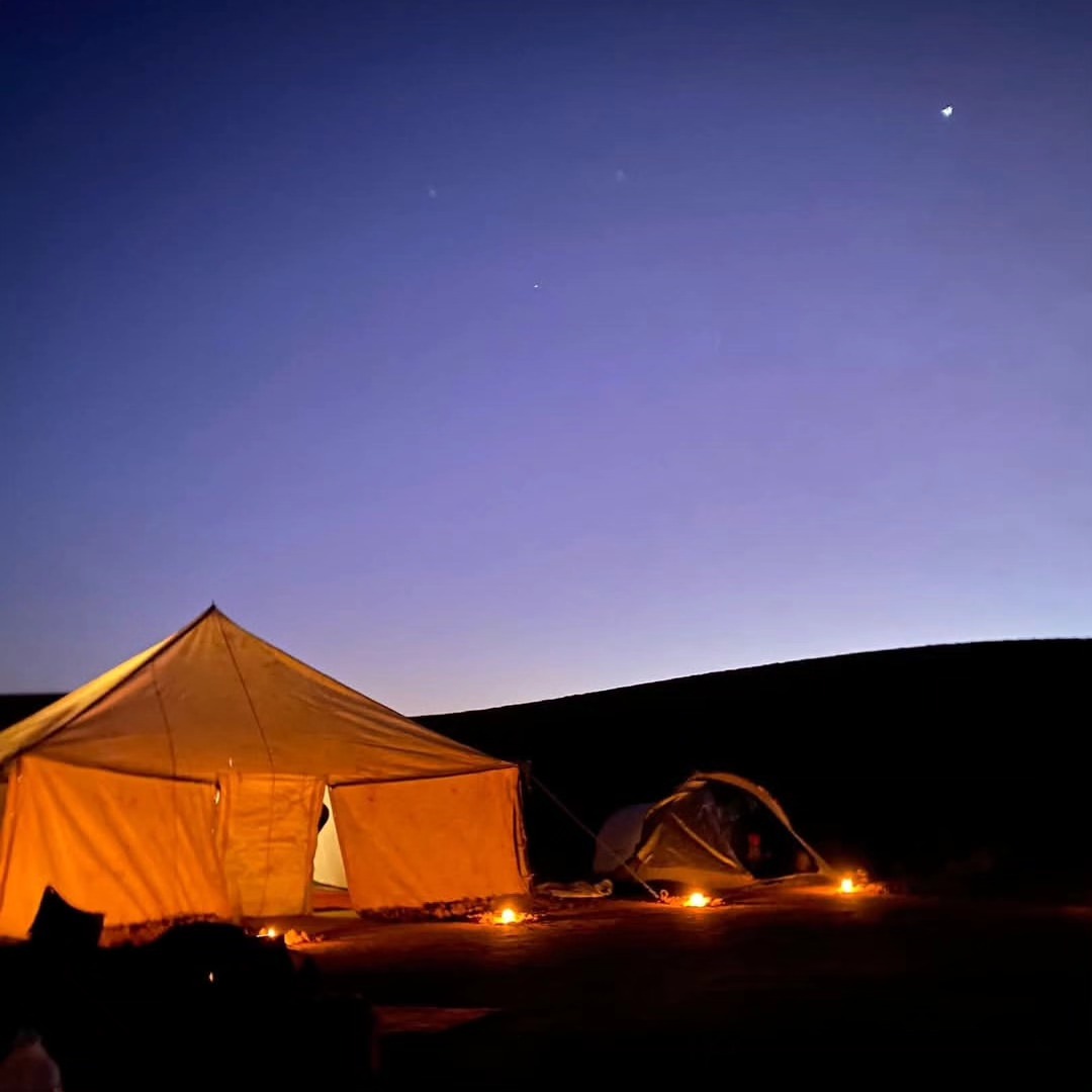 Tents of the Erg Chigaga desert camp at the foot of the dunes