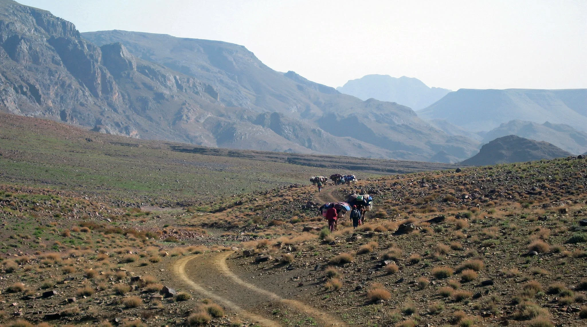 Nomadic caravan following a traditional mountain route in Morocco