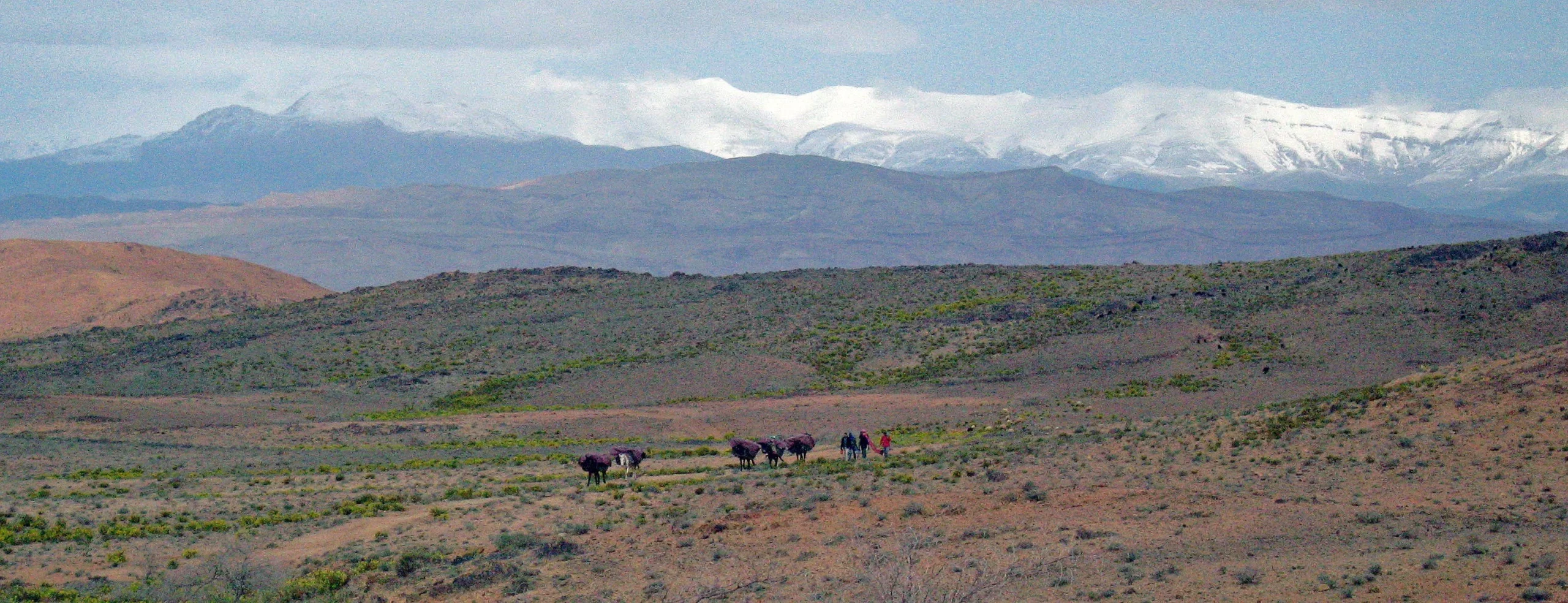 Nomadic journey across a wide Moroccan mountain landscape