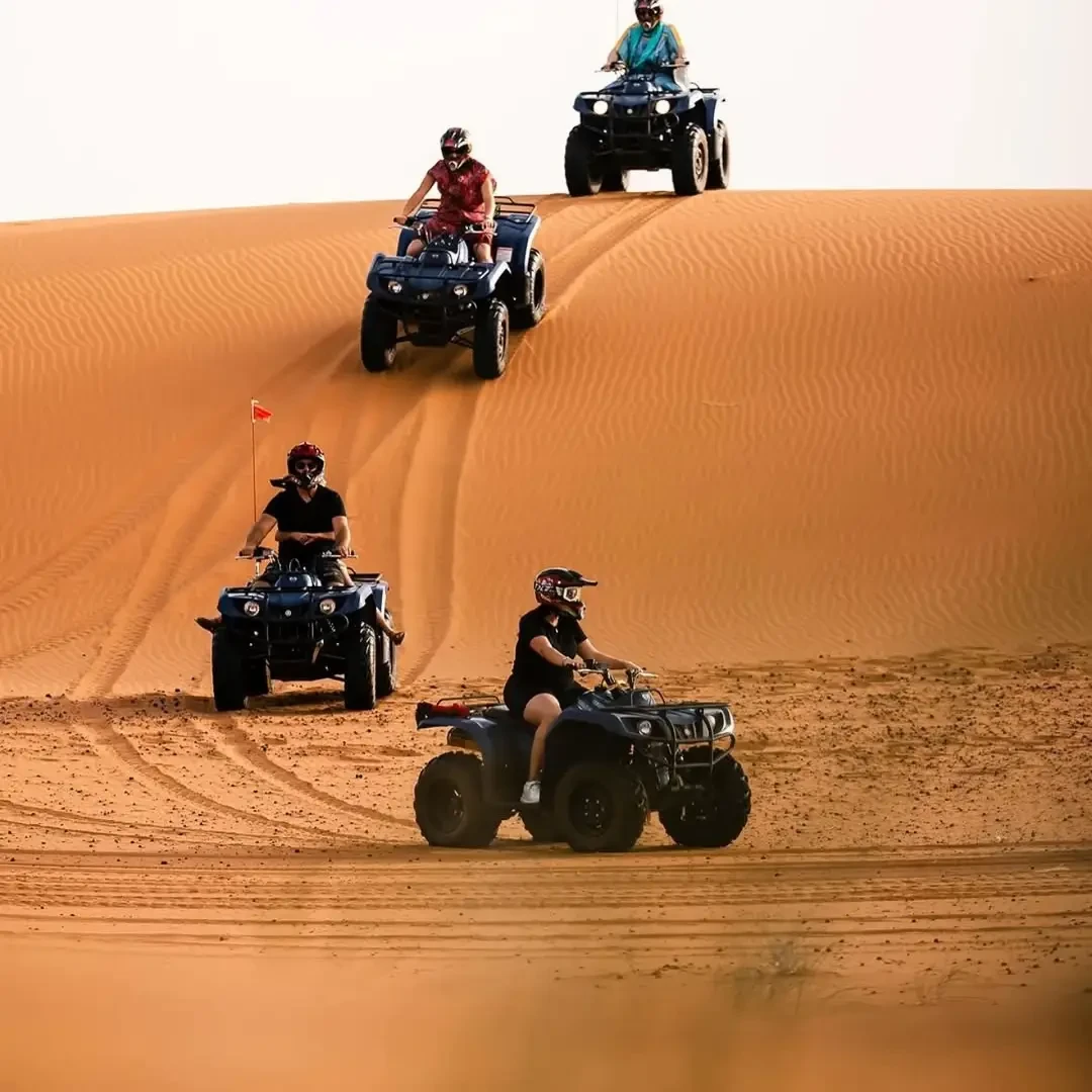 Sunset quad biking in Merzouga with long shadows across the Erg Chebbi dunes