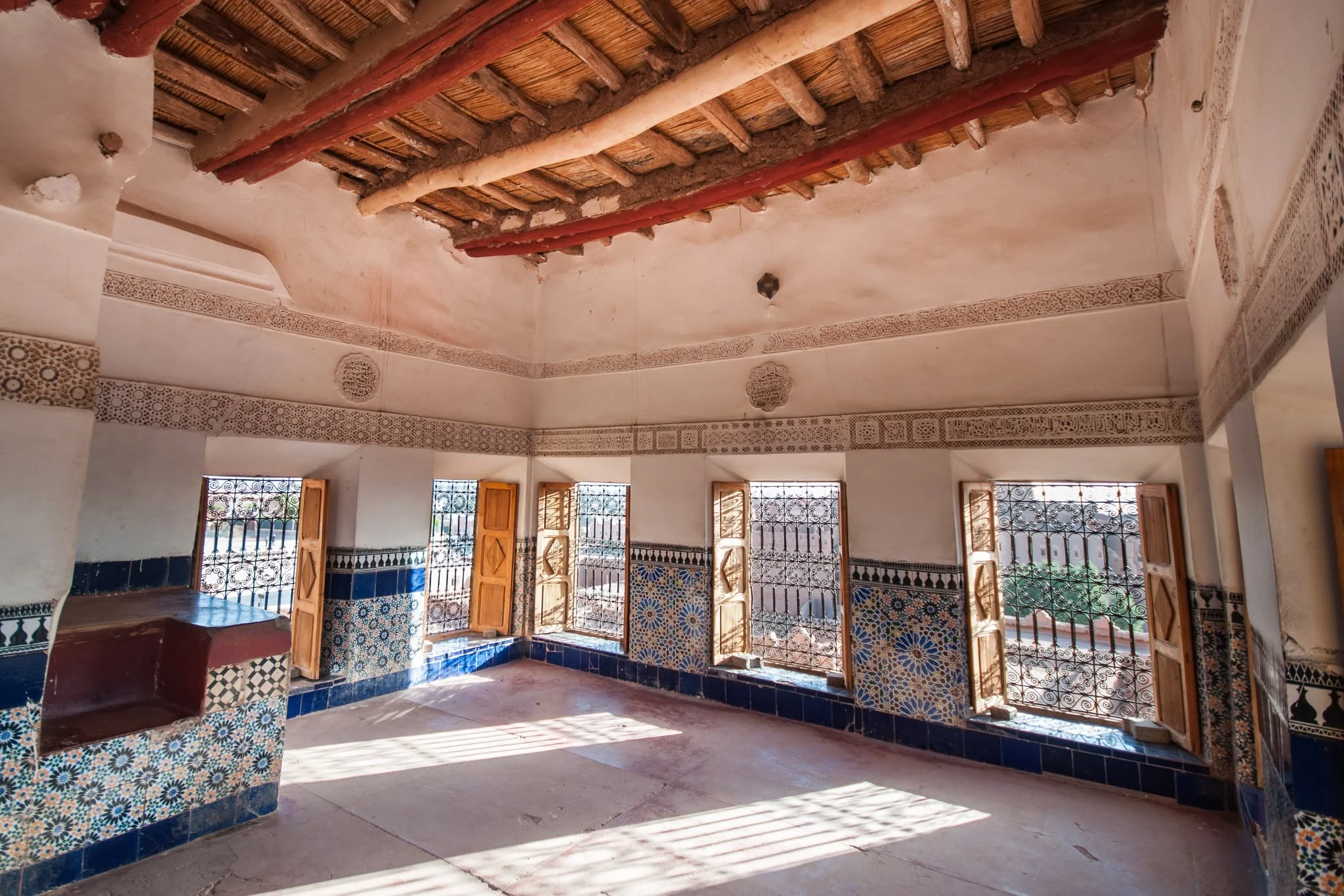 Traditional decorated room inside Taourirt Kasbah with painted ceiling and plasterwork